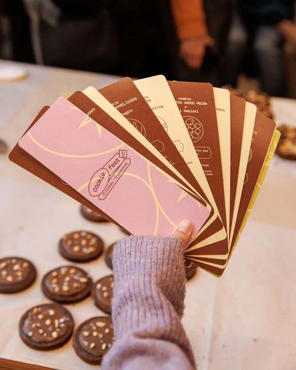 Mano mostrando en abanico las tarjetas de cada cookie de Cookie Fest